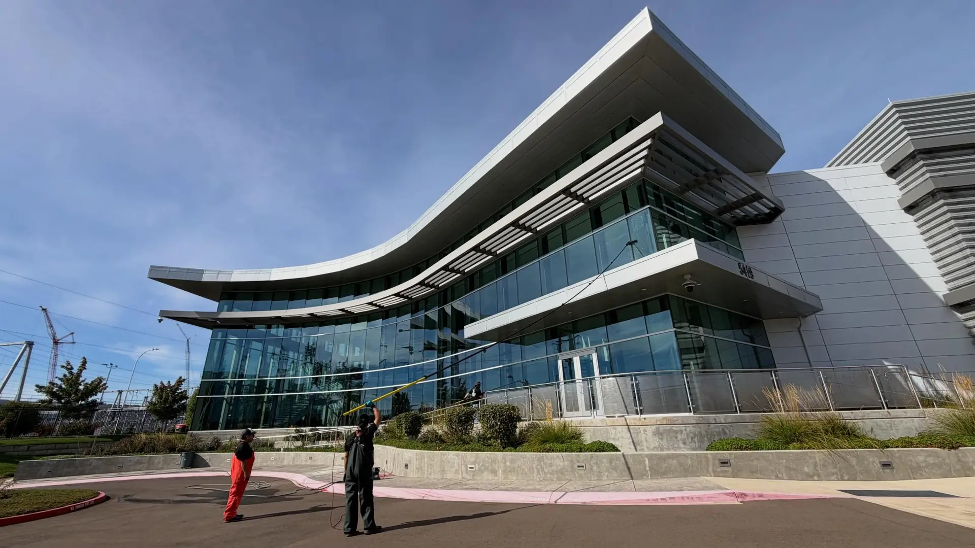 Corporate Cleaning crew working outside a modern glass office campus