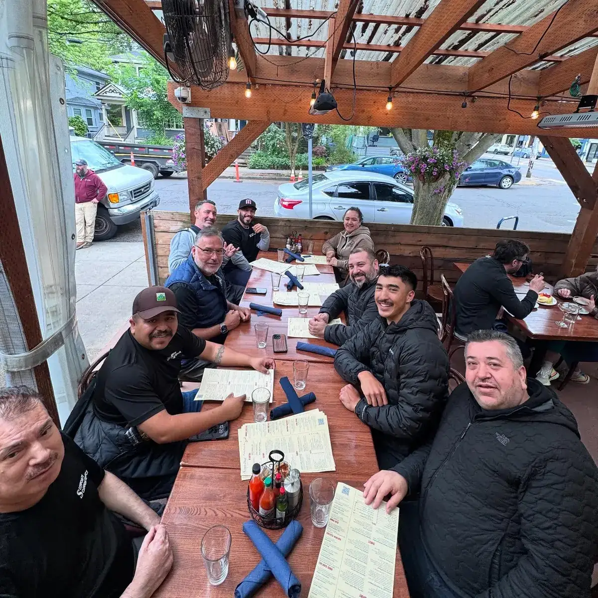 The Corporate Cleaning crew sharing a meal together on a patio